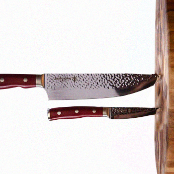 Forged in fire cutlery inserted on a wooden surface
