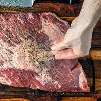Seasoning a beef brisket with salt and pepper