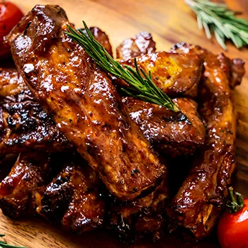 Chopped baby back ribs on wooden board
