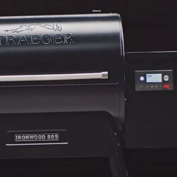Shiny Traeger grill on black background