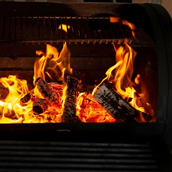 Charcoal grill with bright flame high heat