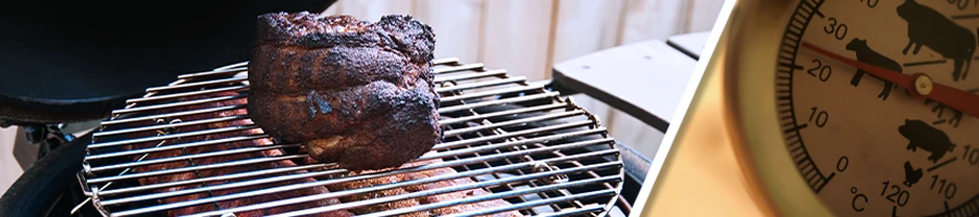 Pork shoulder and ribs on smoker and a meat thermometer