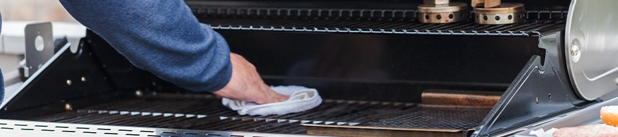 Wiping off the grill with a cloth