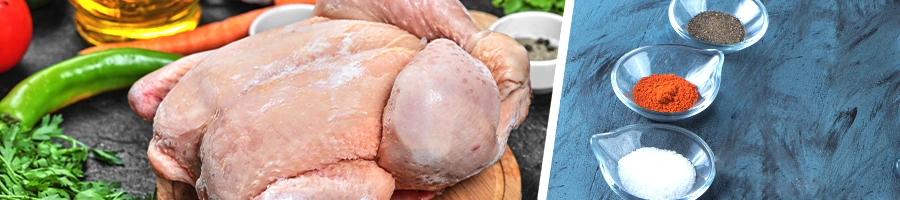 A whole raw chicken with ingredients behind it, spices on the other side