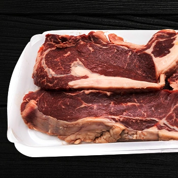 Ribeye meat on a plastic container with marinate