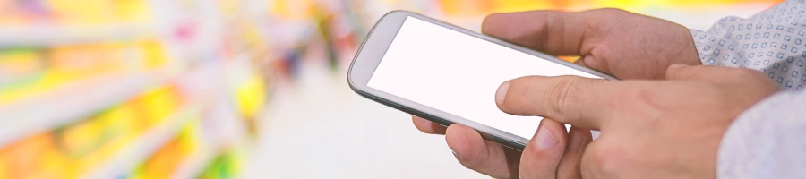 Someone holding a phone inside a supermarket