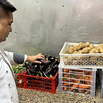 Chef Adonis picking vegetables