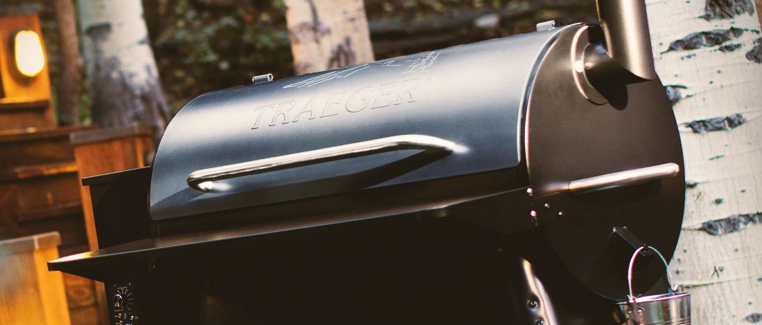 A full black traeger grill outside