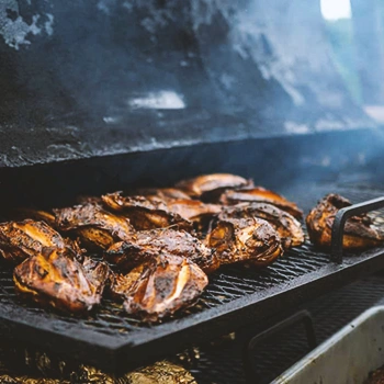 Close up shot of food being smoked in a smoker