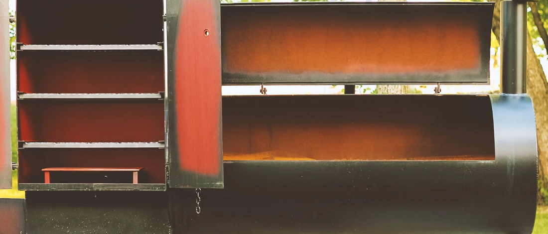 An empty food smoker that is open