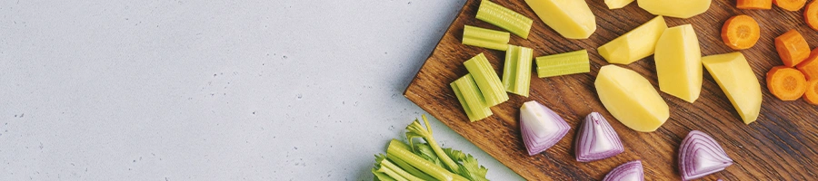 Chopped up vegetables on a wooden cutting board