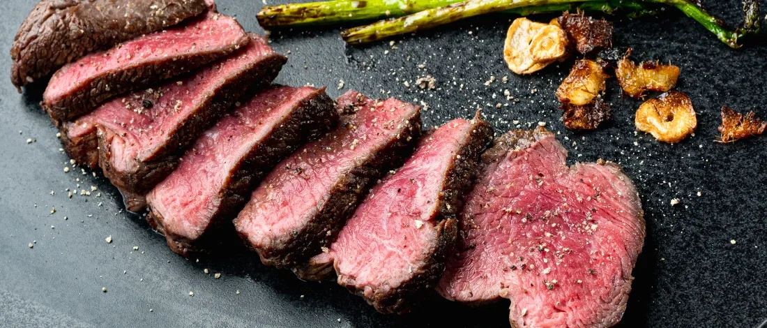 Slices of medium rare steak on a table