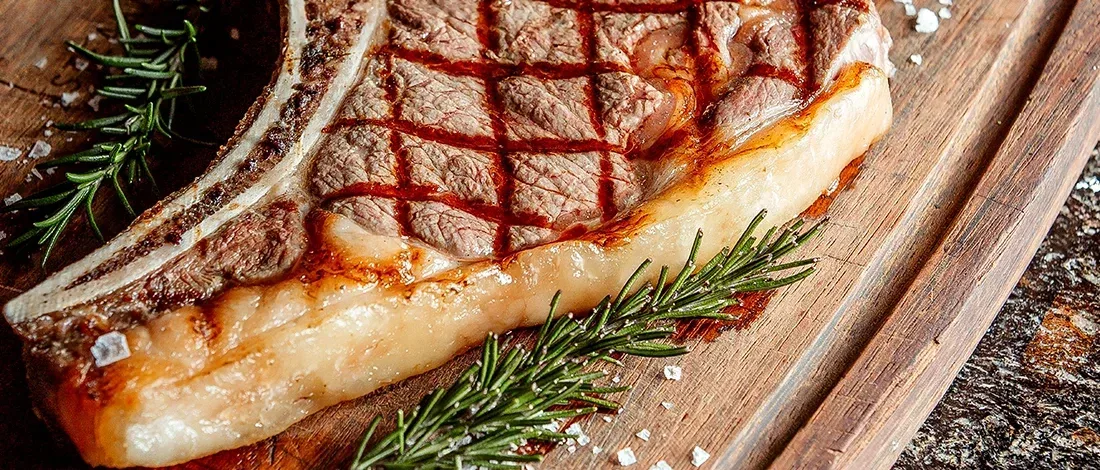 A close up image of grilled ribeye steak