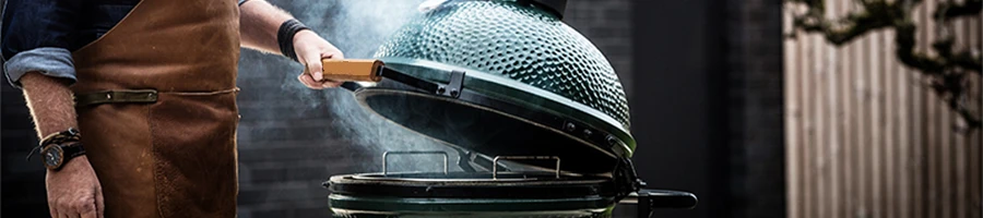 A man opening the Big Green Egg smoker