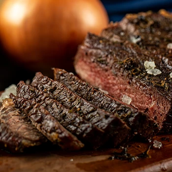 A close up image of steak and onion