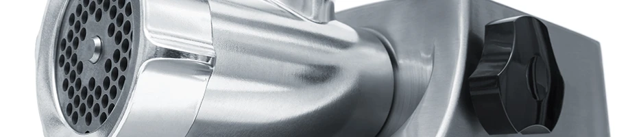 A close up image of a stainless meat grinder