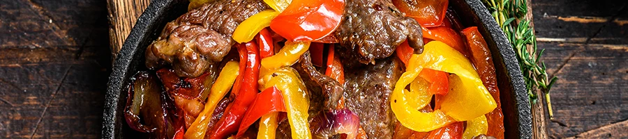 A close up image of fajita dish on a bowl