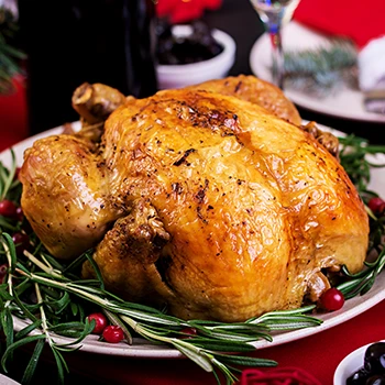 A delicious roasted turkey on a white plate
