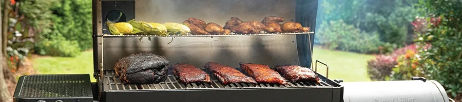 A smoker loaded with smoking meats