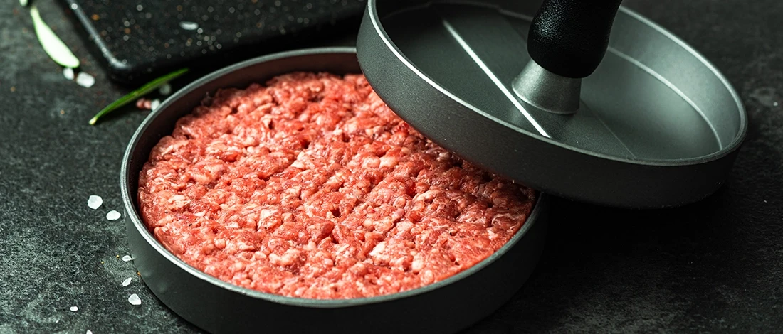 Using a hamburger press to shape hamburger patties