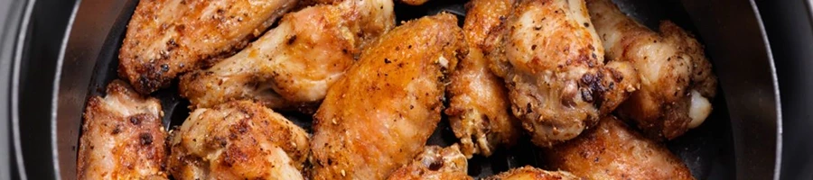 A top view of chicken wings being reheated in an air fryer