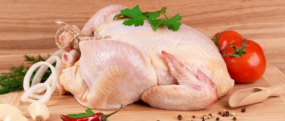 A thawed turkey on top of a wooden board