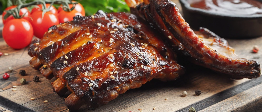 A delicious pork ribs on a wooden board