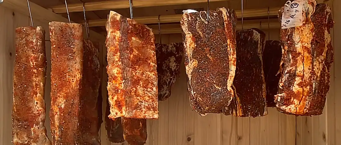 photo of meats in a smokehouse