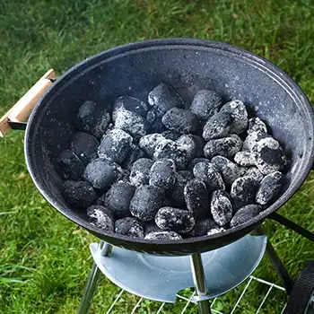 a charcoal grill being heated