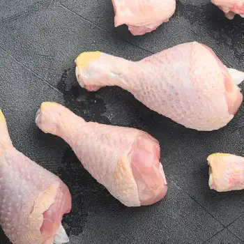 chicken legs on gray stone background