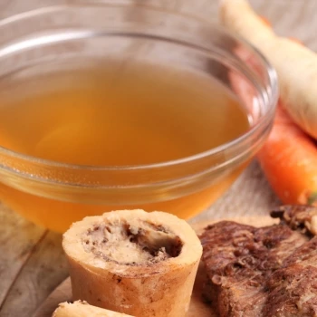 Broth on a bowl and some beef bones