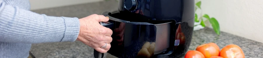 A person reheating a steak in an air fryer