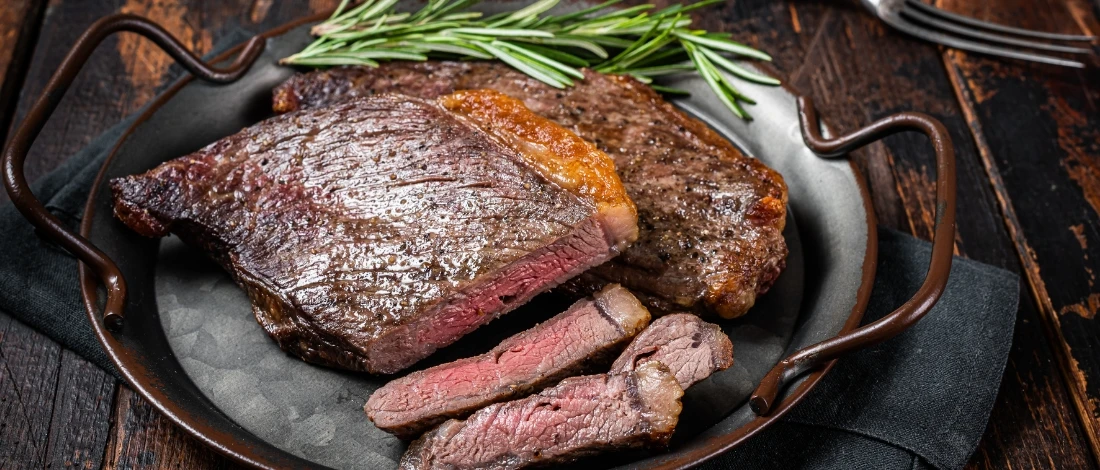 A delicious angus beef steak on a pan
