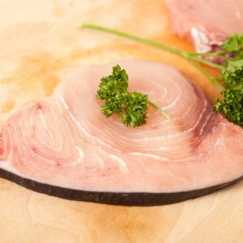 Uncooked swordfish meat on a cutting board
