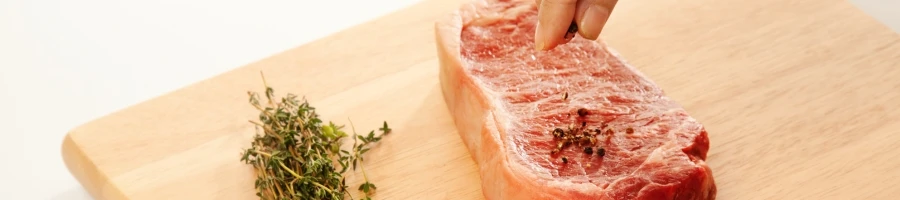 A seasoned meat on a cutting board