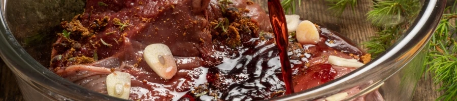 A meat being marinated in a sauce