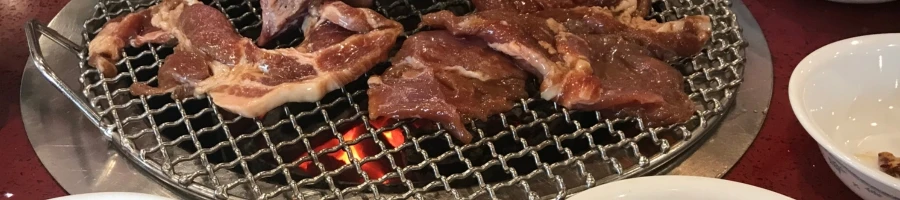 A raw meat being grilled