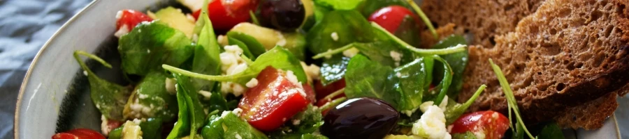 A salad with a bread as a side dish