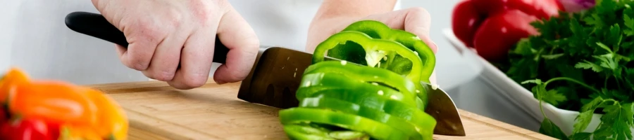 A woman slicing a bell pepper