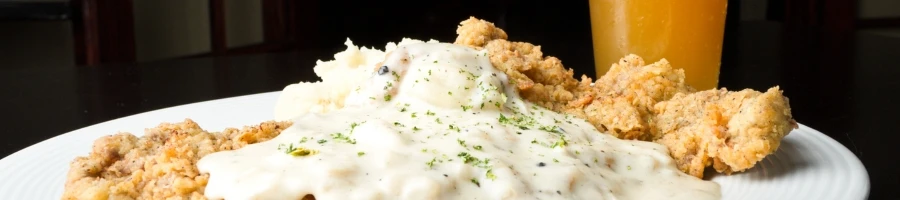 A plate of chicken fried steak with gravy