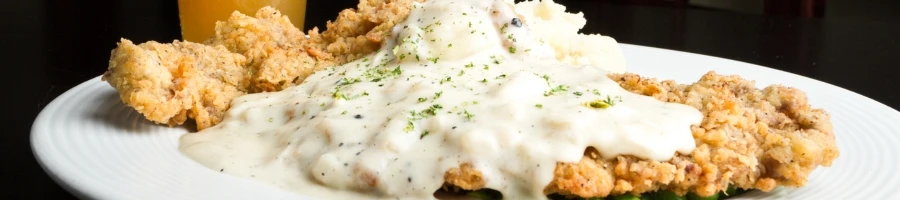 Drowning the chicken fried steak with creamy gravy