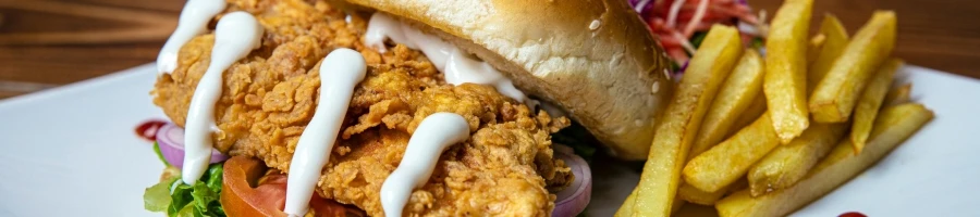 A chicken sandwich with fries