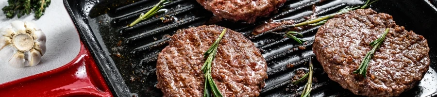 Cooking beef patties on a skillet pan