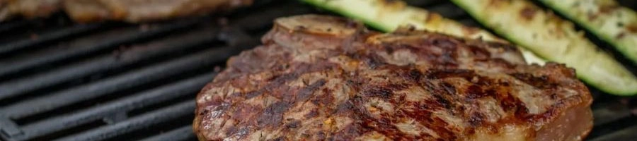 close up image of a beef patty getting grilled