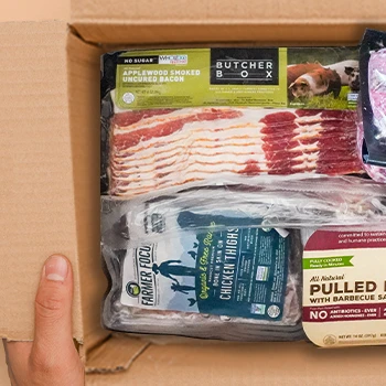 Opening a box of Butcherbox meat products inside