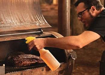 man grilling meat