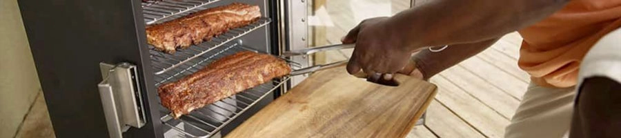 placing meat inside a smoker