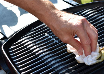 wiping the cast iron grill grates