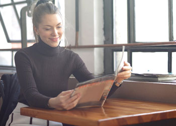 woman looking through menu