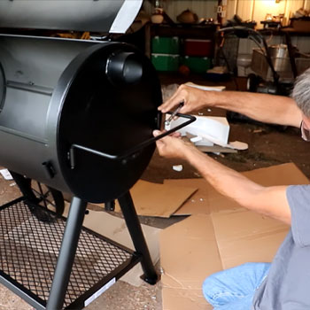 Man seasoning a smoker